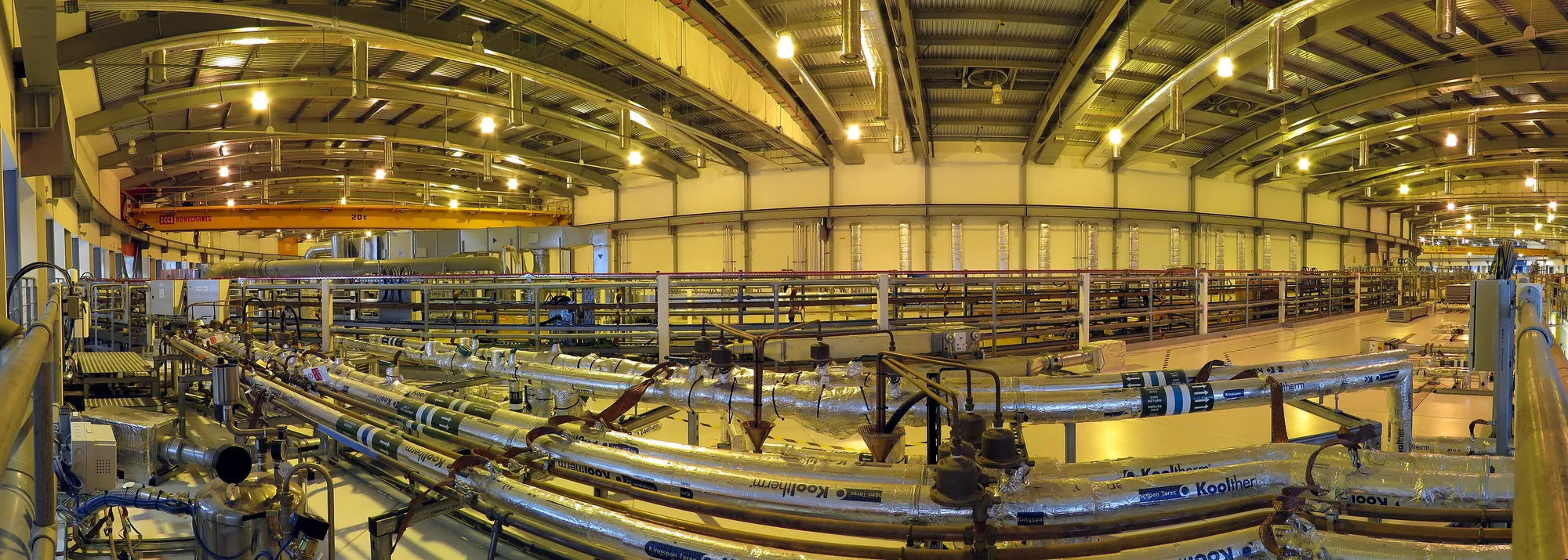 Inside the storage-ring hall of a synchrotron: the electron beam circulates around the ring while beamlines branch off to experimental stations.